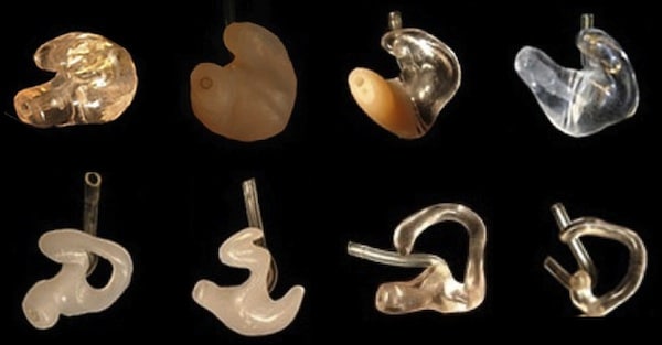 Figure 3. A sampling of custom earmolds for hearing aids. Some are made of hard acrylic, some are soft material, and some are a combination. The shape of that part showing in the bowl of the ear, as well as that being directed into the ear are designed for different purposes: cosmetic, function, or both.