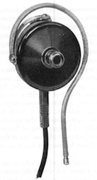 Figure 5.  Early hearing aid “receiver.”  This configuration, with a shaped wire to hold it to the ear rather than a headband, had a nubbin to which some type of earmold could be affixed.  Additionally, it was considerably reduced in size from earlier headphones, allowing for the elimination of the headband.  (Photo from Berger, 1974).